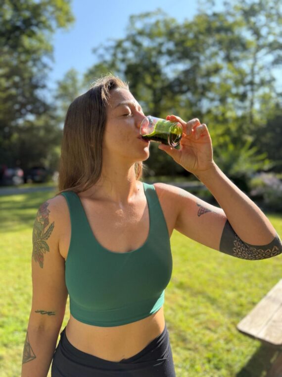 Yoga Girl Drinking Wheatgrass Juice Outside